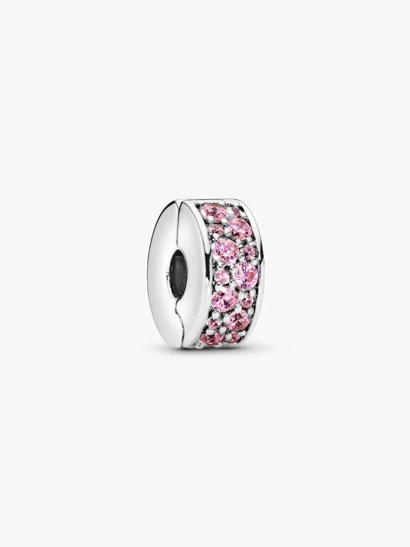 Silver charm with pink gemstones on a white background