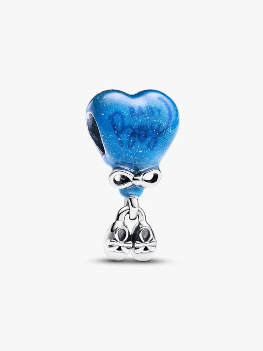 A silver charm featuring a glittery blue heart-shaped top with the word 'Dream' written inside, connected by a bow to a dangling silver bunny charm, shown on a light gray background.