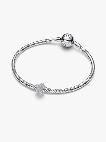 Silver bracelet with a star-shaped charm on a white background