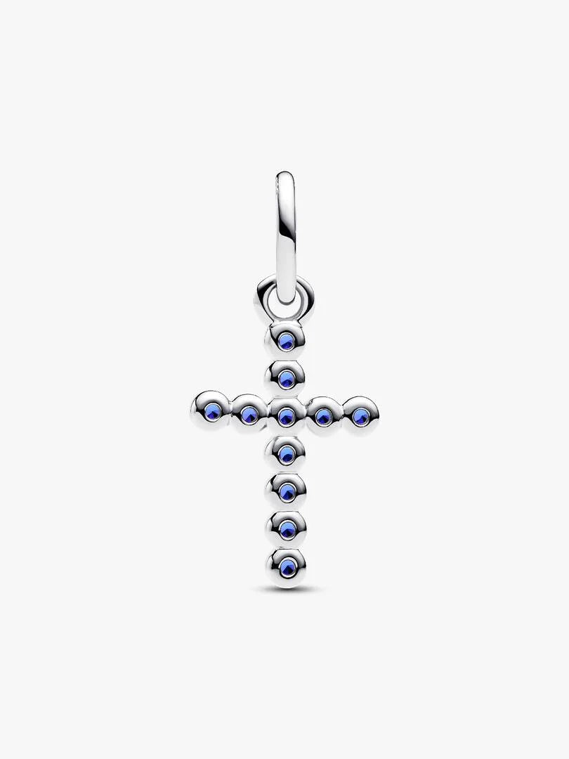 Silver cross pendant with blue gemstones on a white background