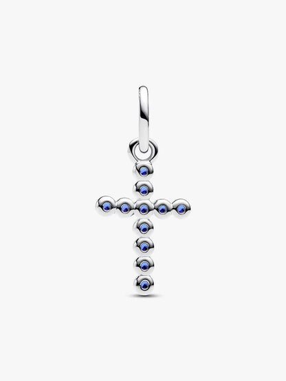 Silver cross pendant with blue gemstones on a white background
