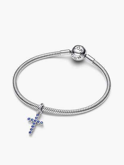 Silver bracelet with a cross charm on a white background