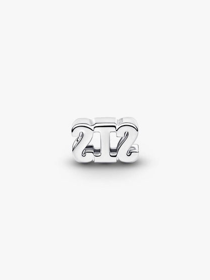 Silver '24/7' charm on a white background