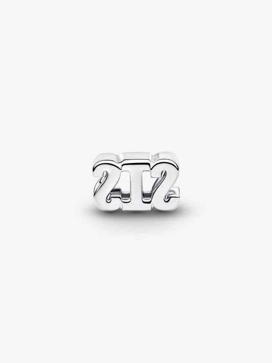 Silver '24/7' charm on a white background