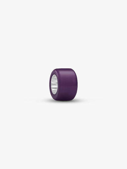 A single dark purple cylindrical bead with a silver metallic inner core, shown on a clean white background.