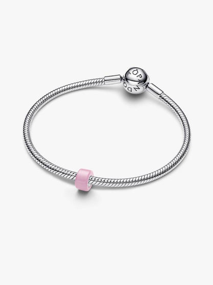 A silver-toned snake chain bracelet with a pink cylindrical charm, displayed on a clean white background. The clasp features the Pandora logo engraved, identifying the brand.