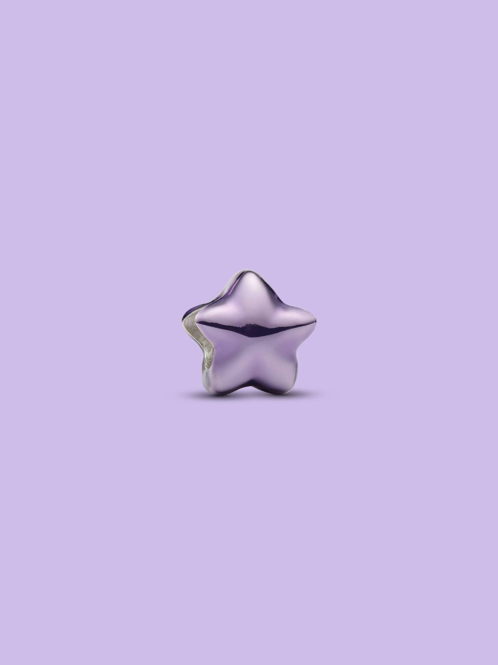 A small metallic star-shaped charm or bead in a shiny lavender-purple finish, centered against a solid light purple background.