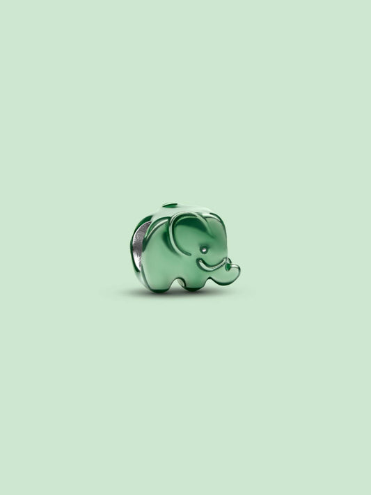 A small glossy green elephant charm or bead with silver-toned edges, centered on a pale mint green background.