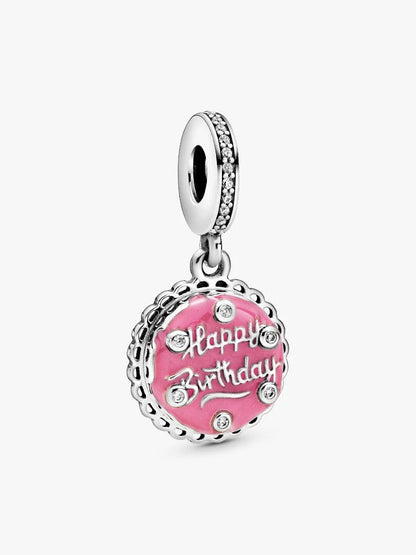Silver charm with pink enamel 'Happy Birthday' text on a white background
