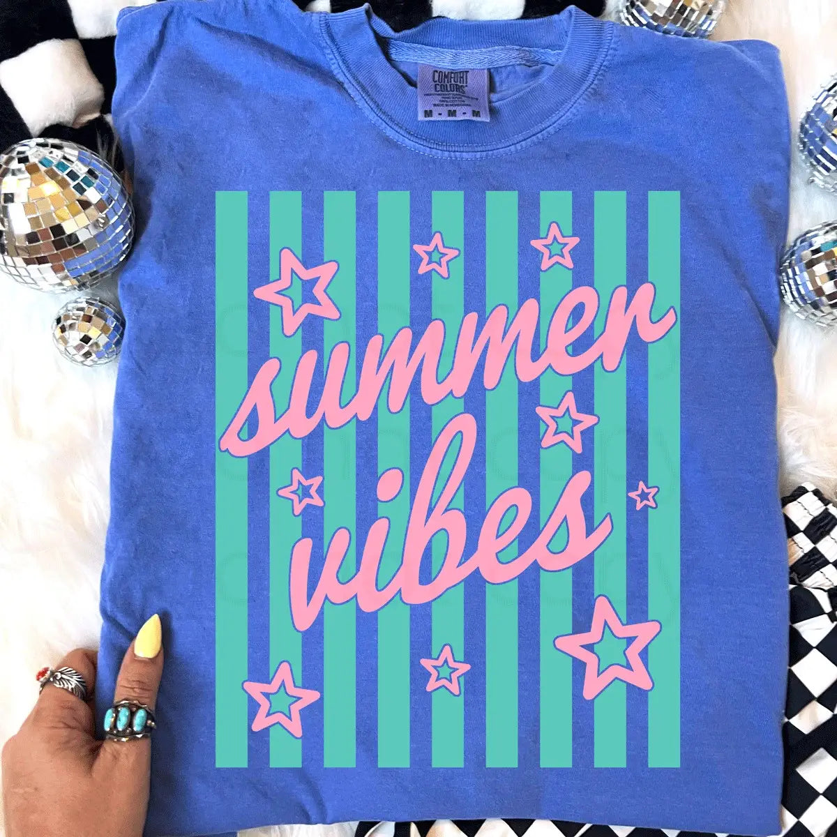 Blue t-shirt with 'summer vibes' text and stars on a striped background