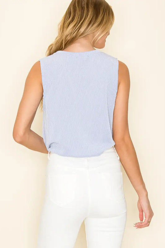 woman wearing cropped tie front top with white pants