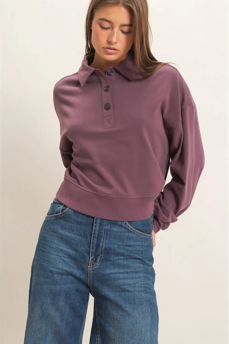 woman in button sweatshirt and jeans