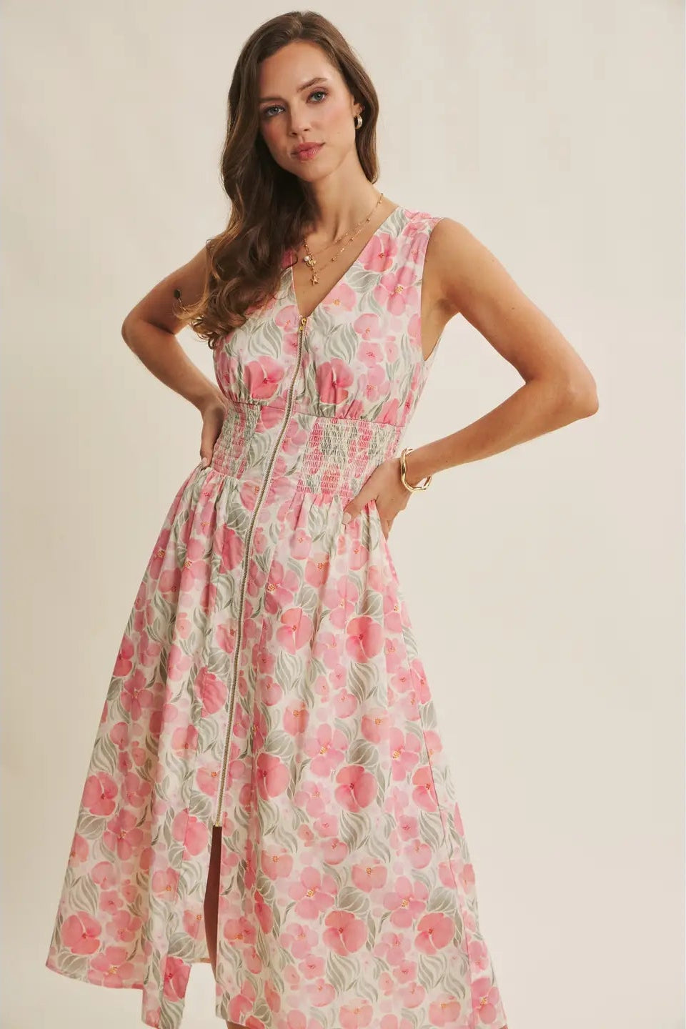 Woman wearing a floral dress against a plain background