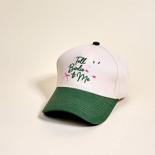 White and green cap with 'Talk Birdie to Me' text on a beige background
