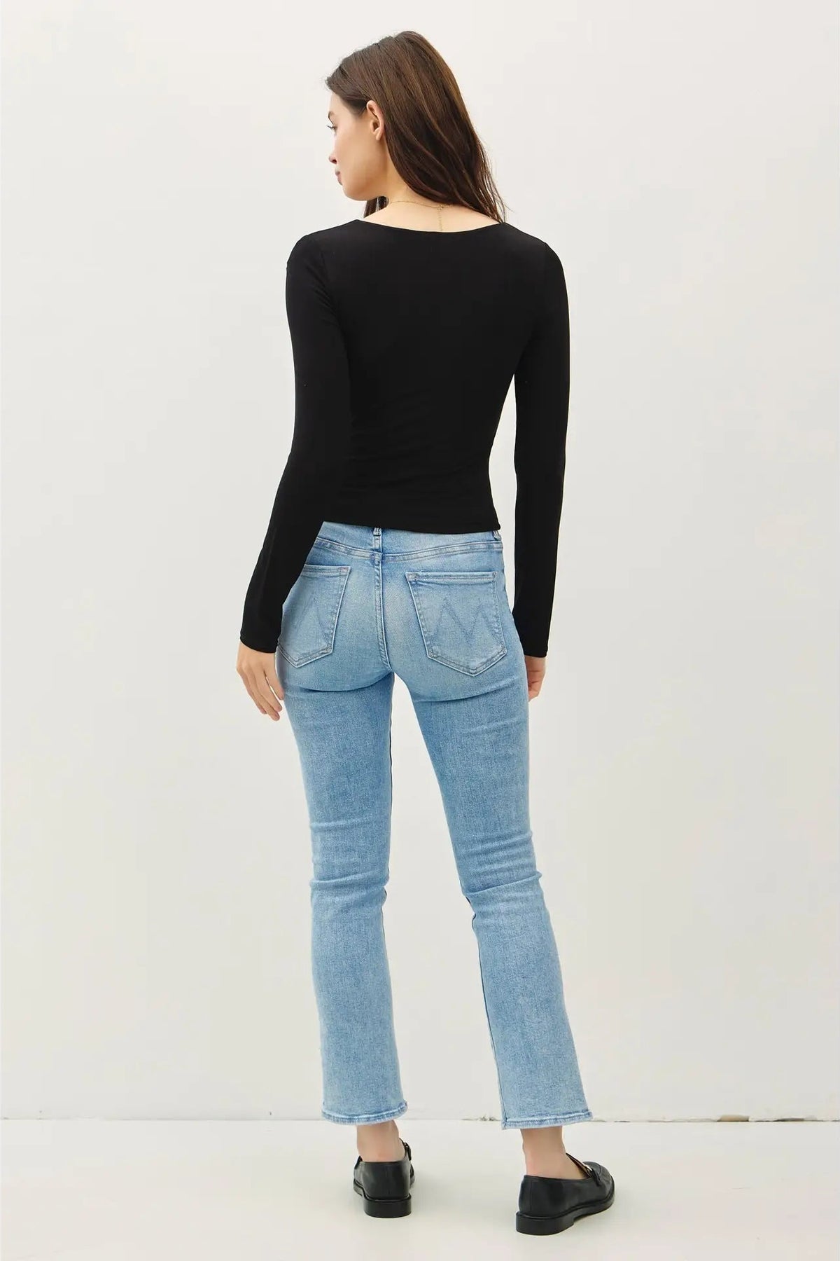 woman wearing square neck long sleeve top with jeans