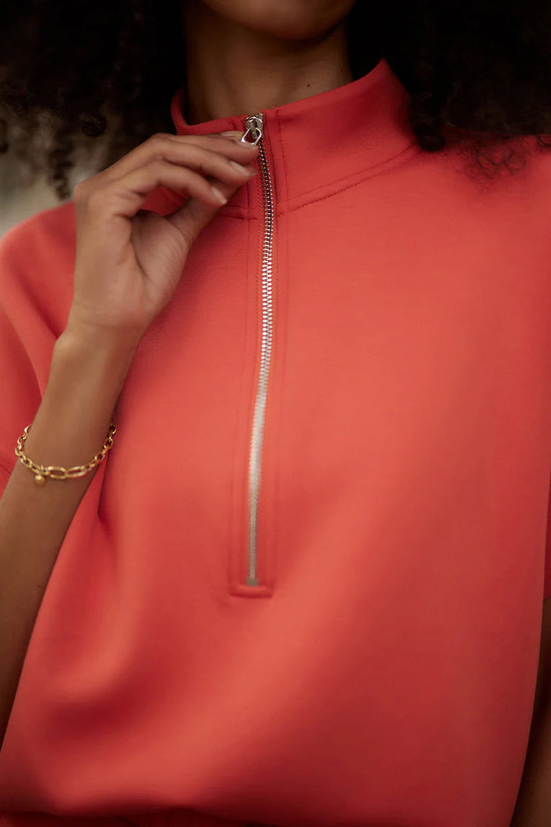 woman wearing red zip up top