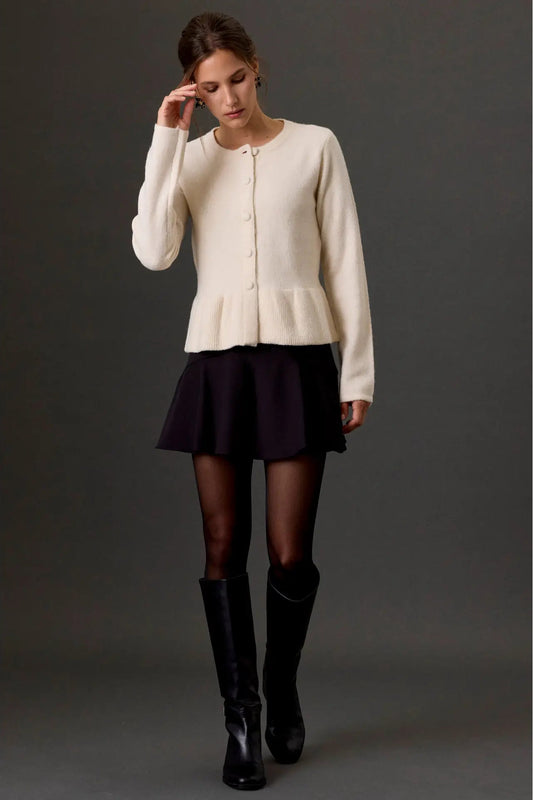woman in cardigan and skirt and boots