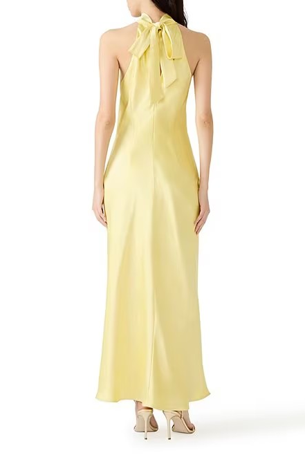 Yellow halter neck dress on a white background