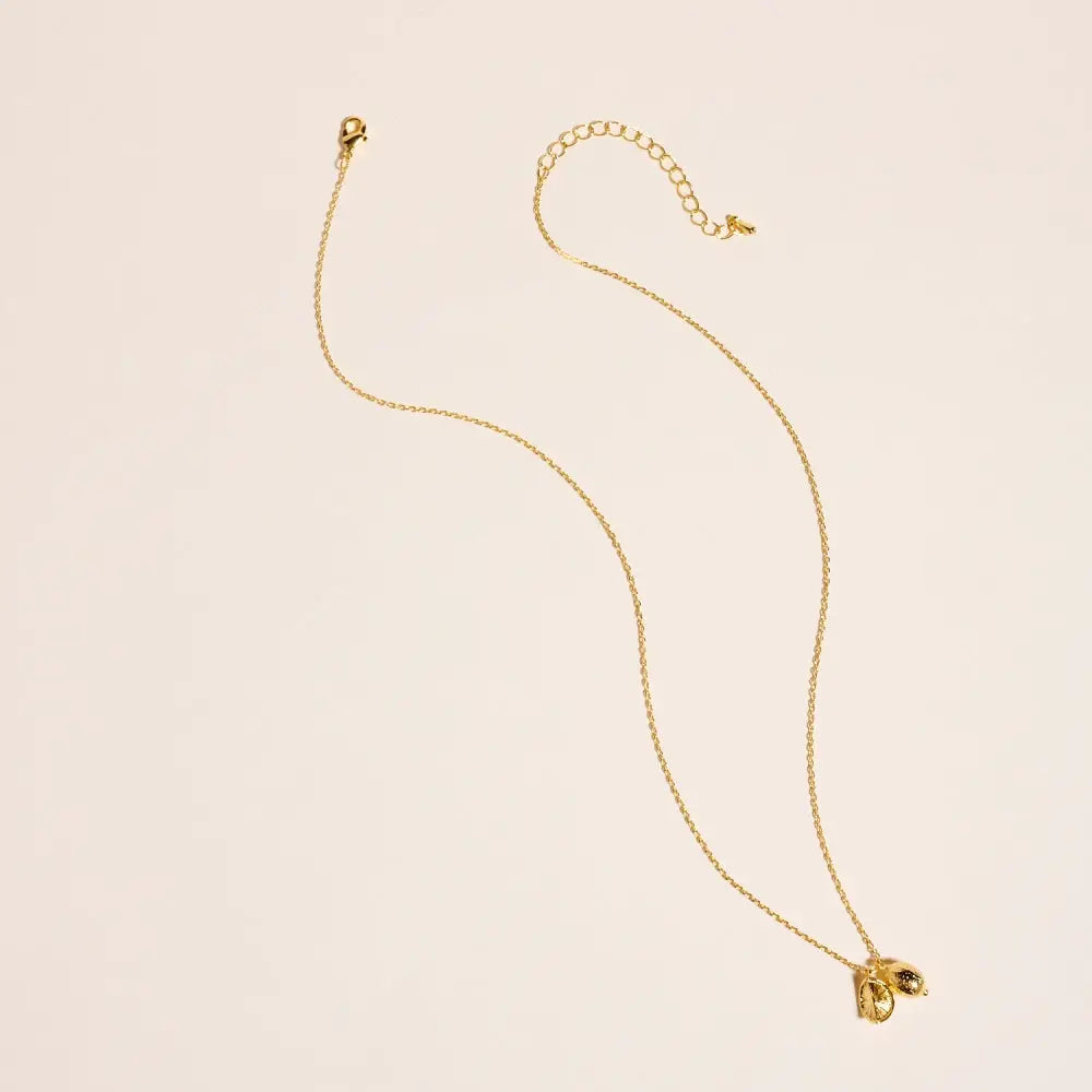 Gold necklace on a beige background