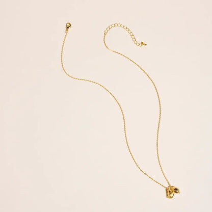 Gold necklace on a beige background