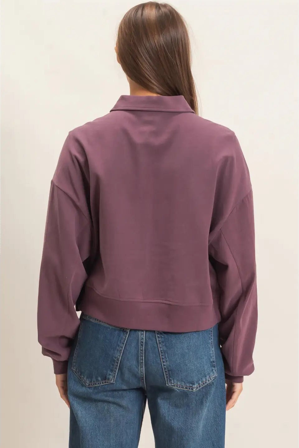 back view of woman in sweatshirt and jeans