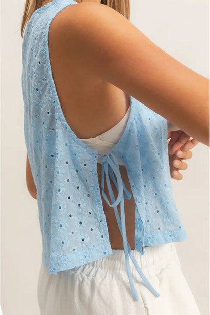 Light blue sleeveless top with lace details worn by a person on a plain background