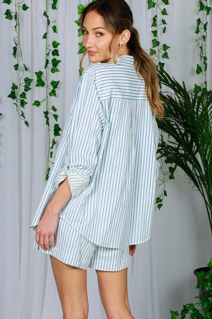 woman wearing blue and white button up shirt and shorts
