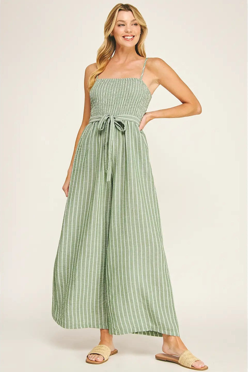 Woman wearing a green striped dress on a white background