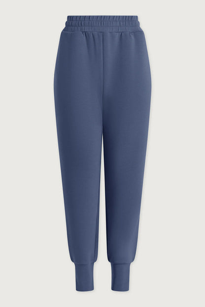 Blue sweatpants on a light gray background