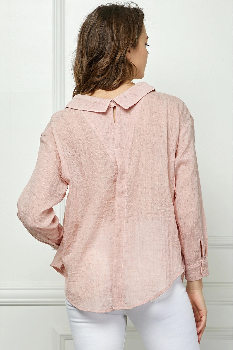 Woman wearing a pink blouse with a white background