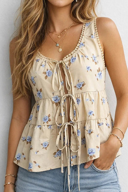 Woman wearing a floral sleeveless top with a white background