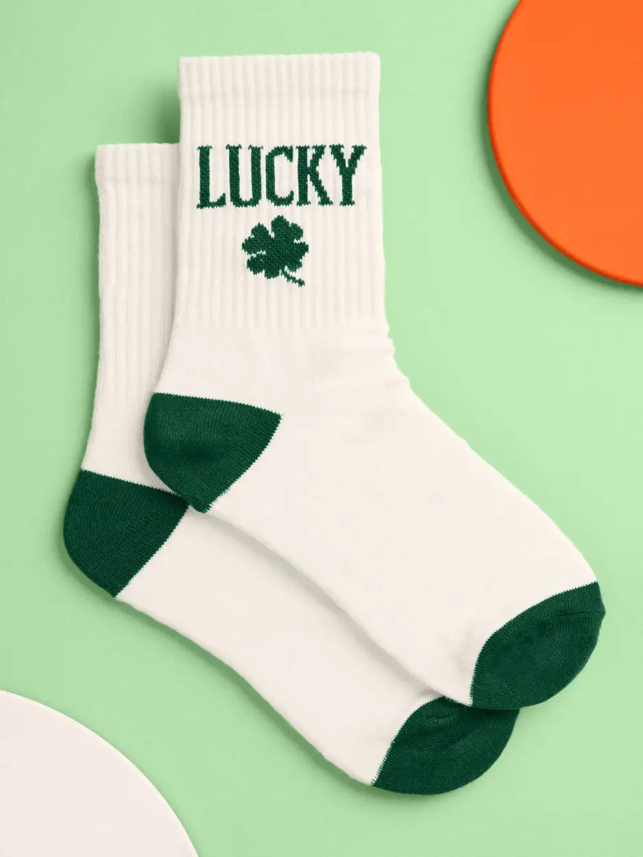 White socks with green accents and 'LUCKY' text on a light green background