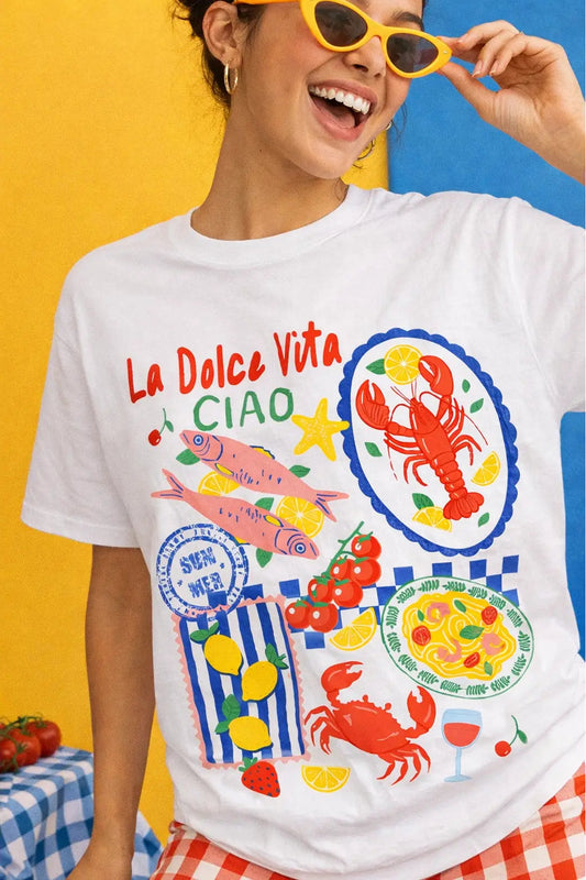 Person wearing a white t-shirt with colorful graphics and text against a multicolored background