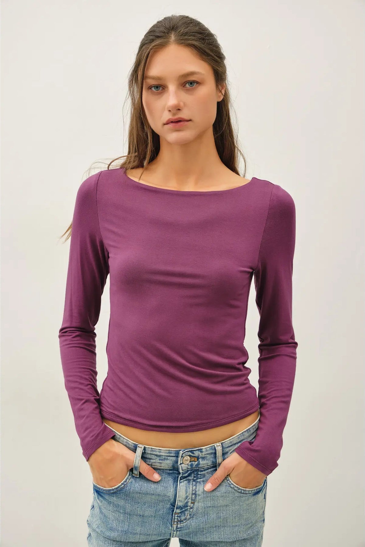 woman in long sleeve top and jeans