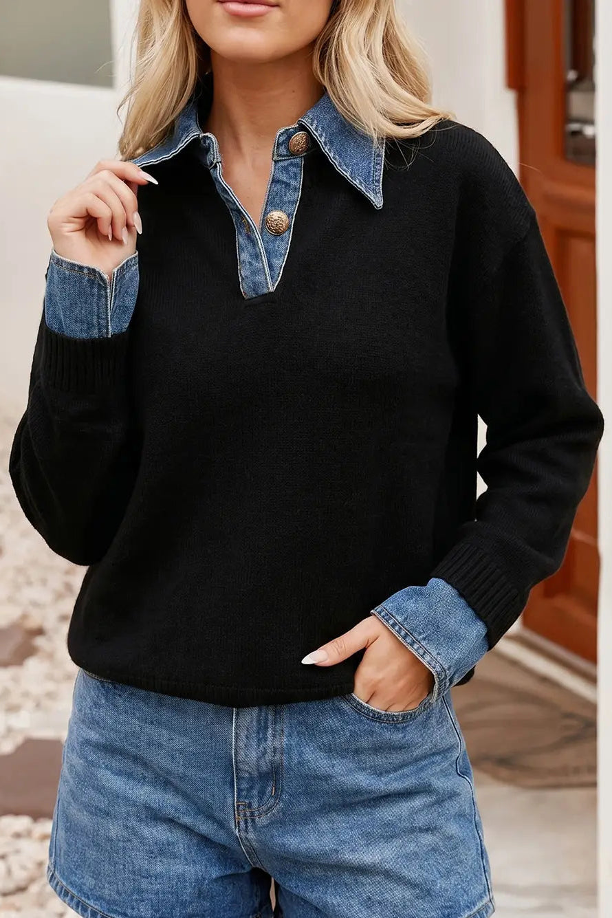A woman wearing a black knit sweater with a denim collar and matching denim button placket, paired with blue denim shorts, shown in an outdoor setting.