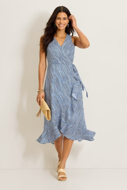 Woman wearing a blue striped dress against a plain background