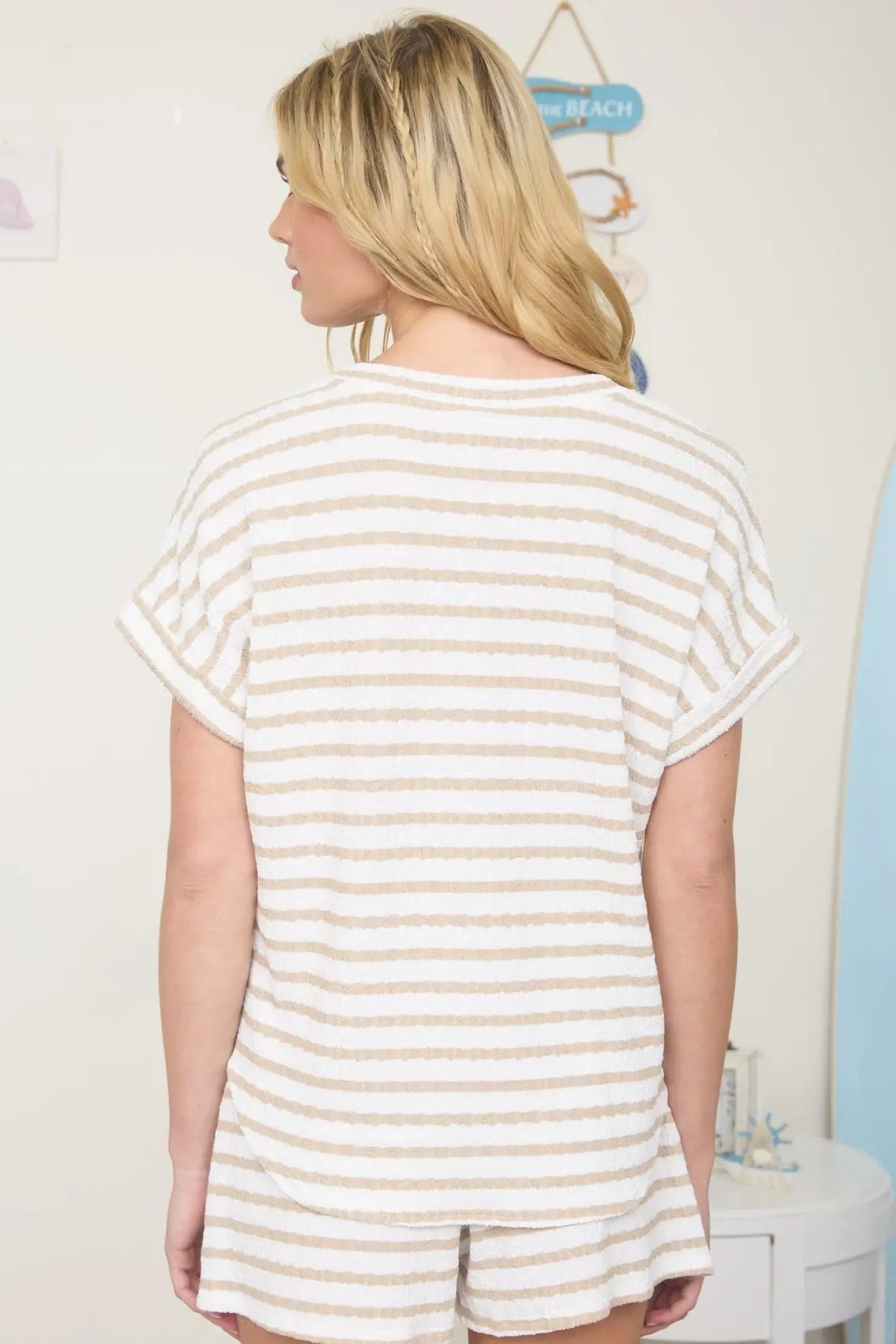 Person wearing a striped outfit in a bathroom setting