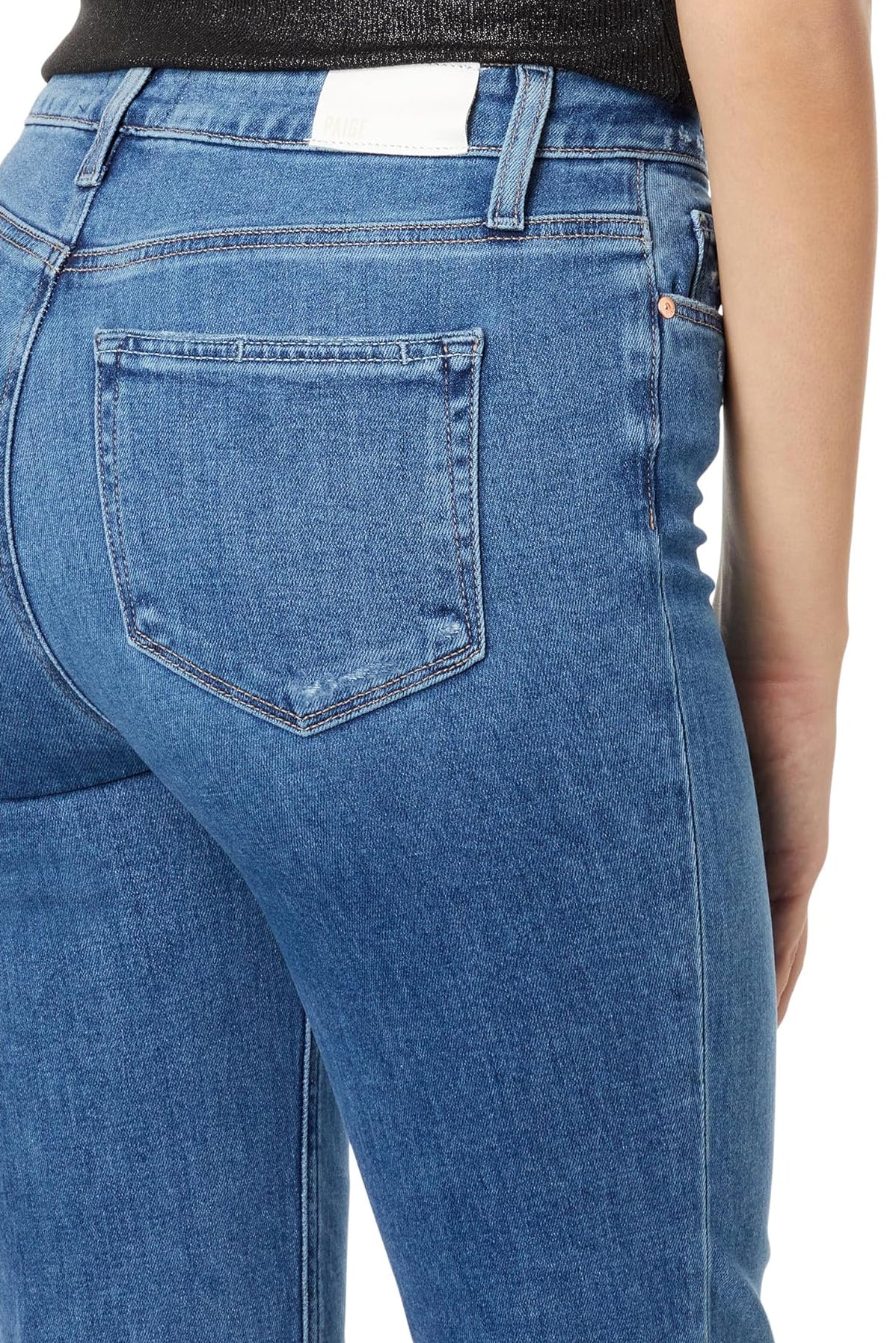 Blue jeans with a focus on the back pocket on a white background