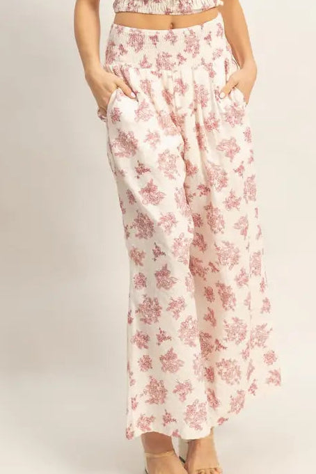 Woman wearing a floral two-piece outfit on a white background