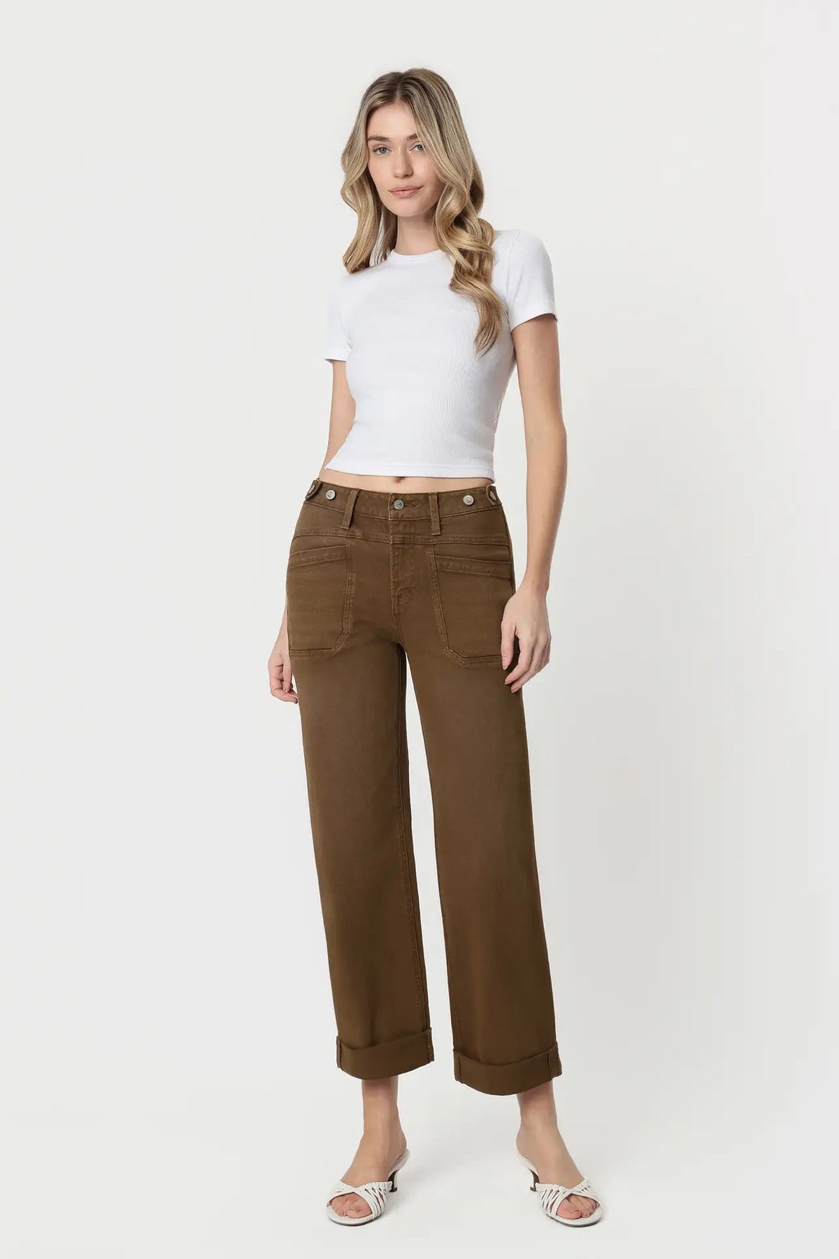 woman in white top and brown jeans