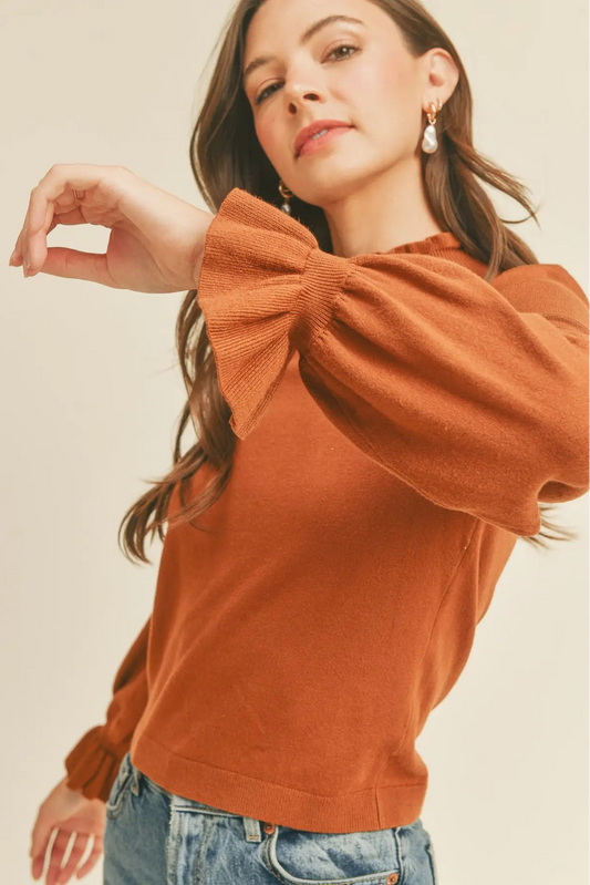 woman in ruffle sleeve sweater 