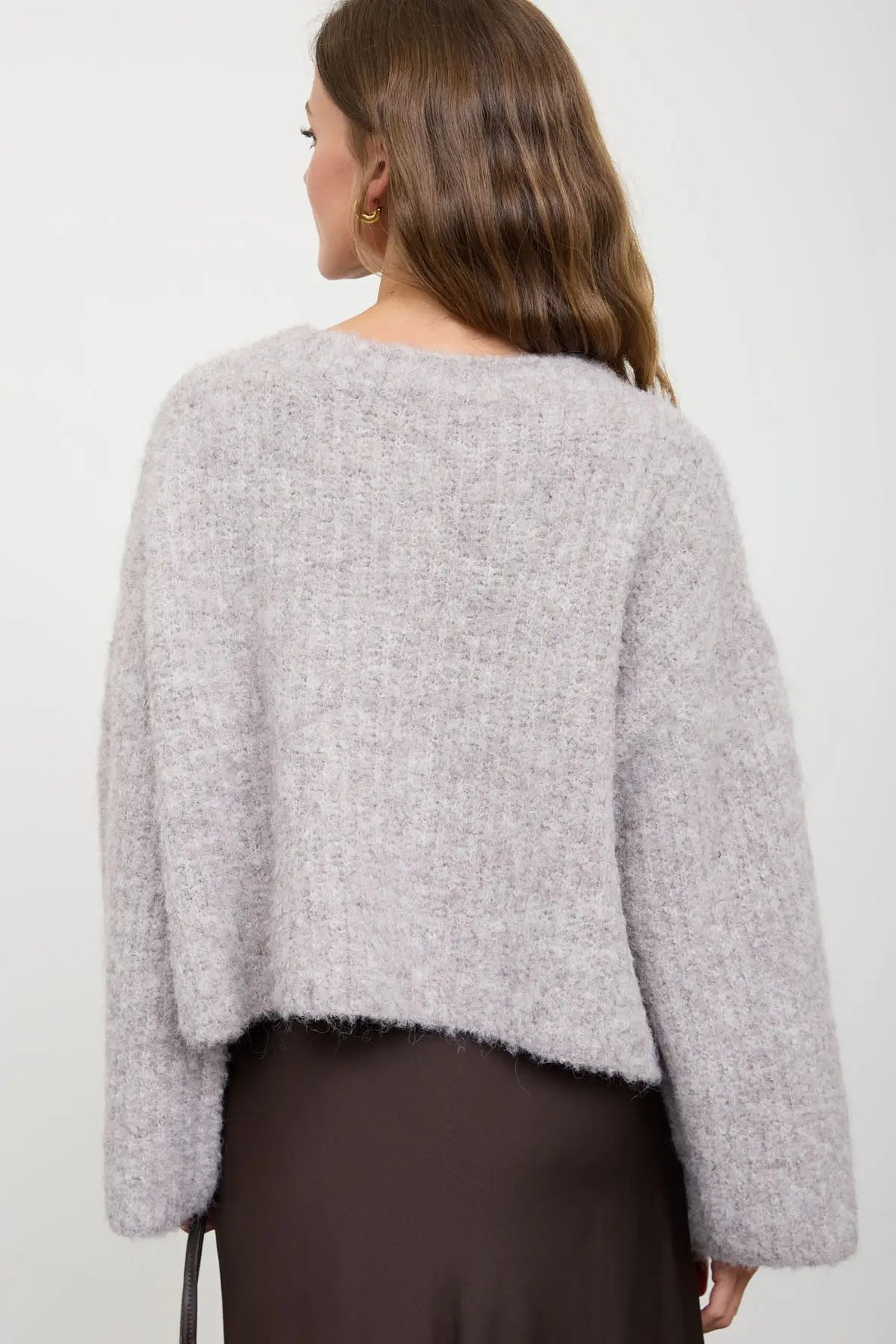 woman in fuzzy cardigan and skirt 