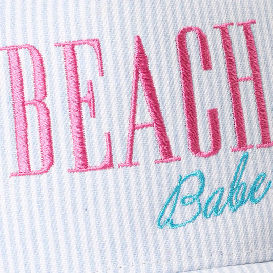 Embroidered text 'BEACH Babe' on a textured fabric background