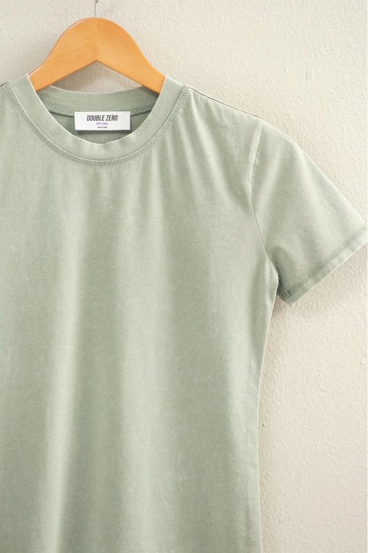 Green t-shirt on a hanger against a light background