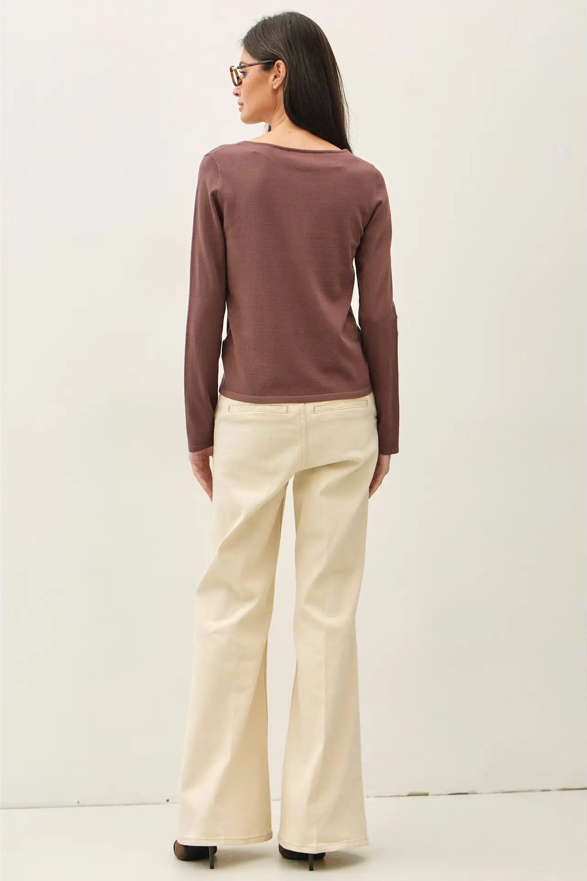 back view of woman in long sleeve top 
