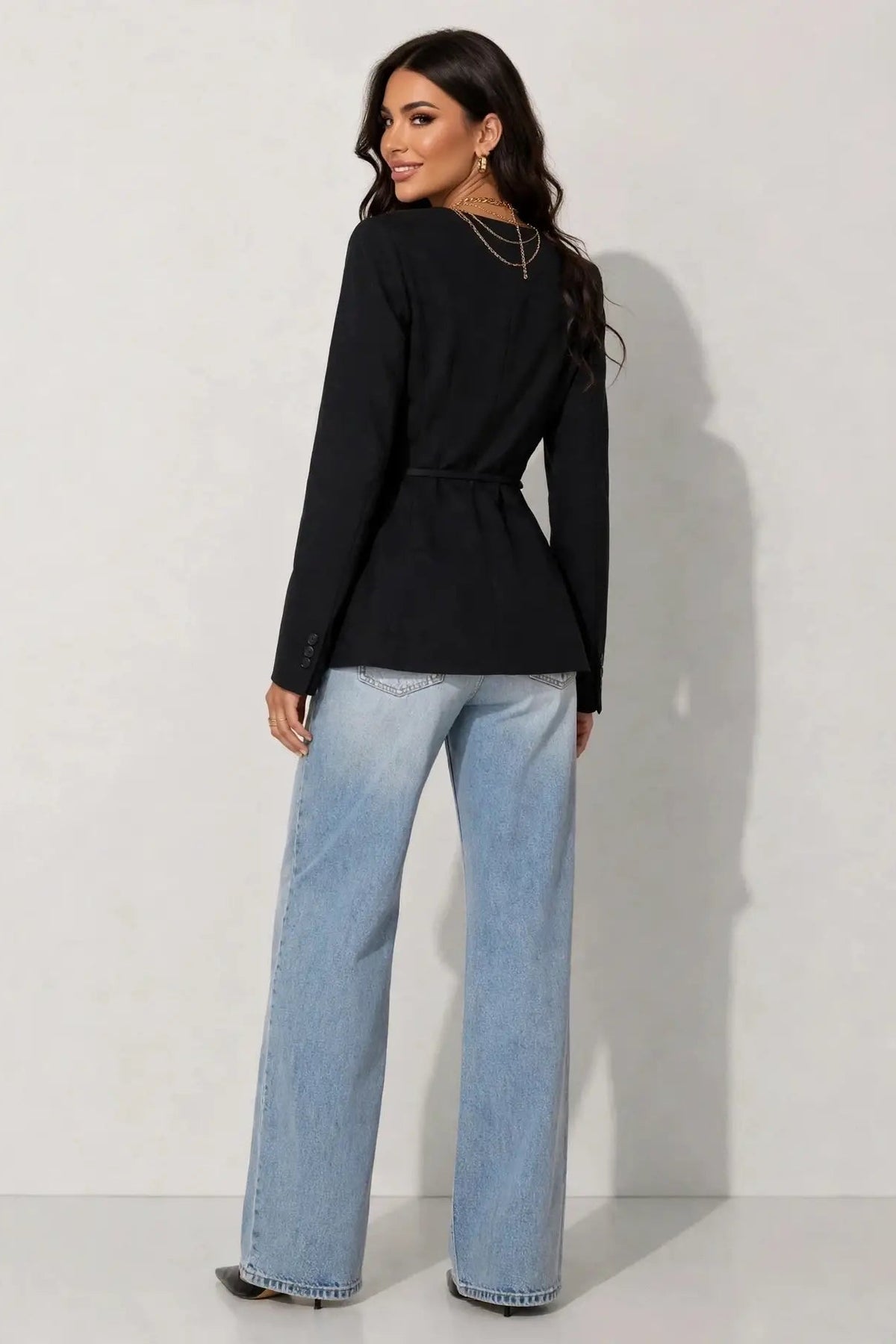 back view of woman in blazer and jeans