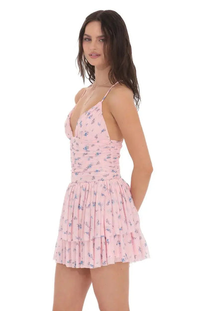 Woman wearing a pink floral dress on a white background