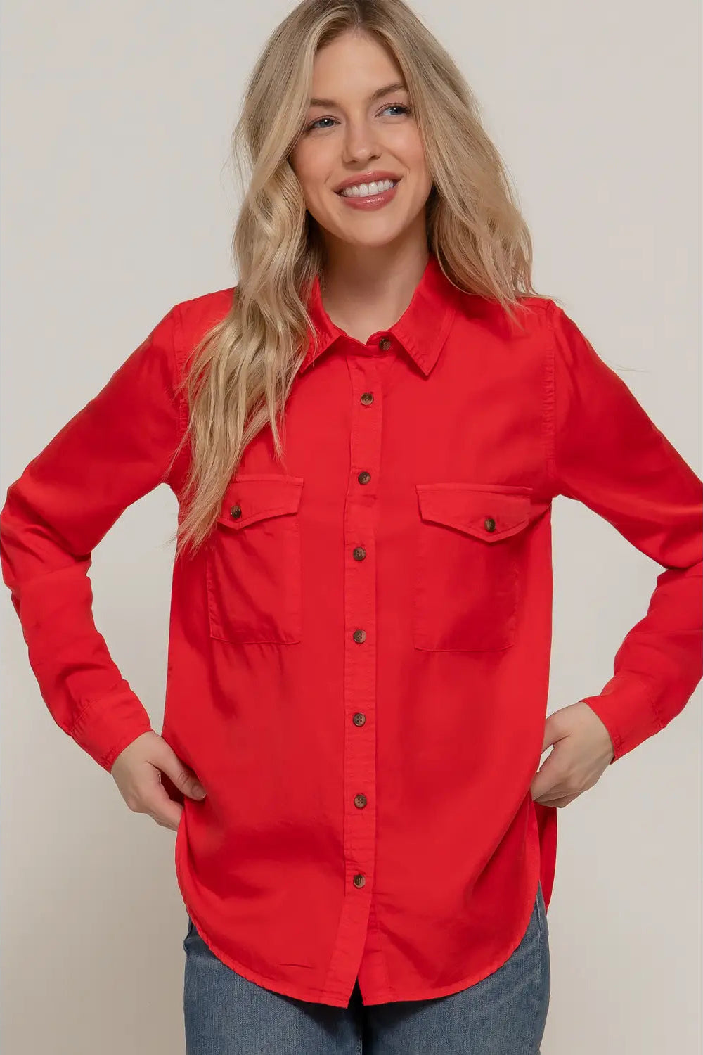 Woman wearing a red shirt with a neutral background