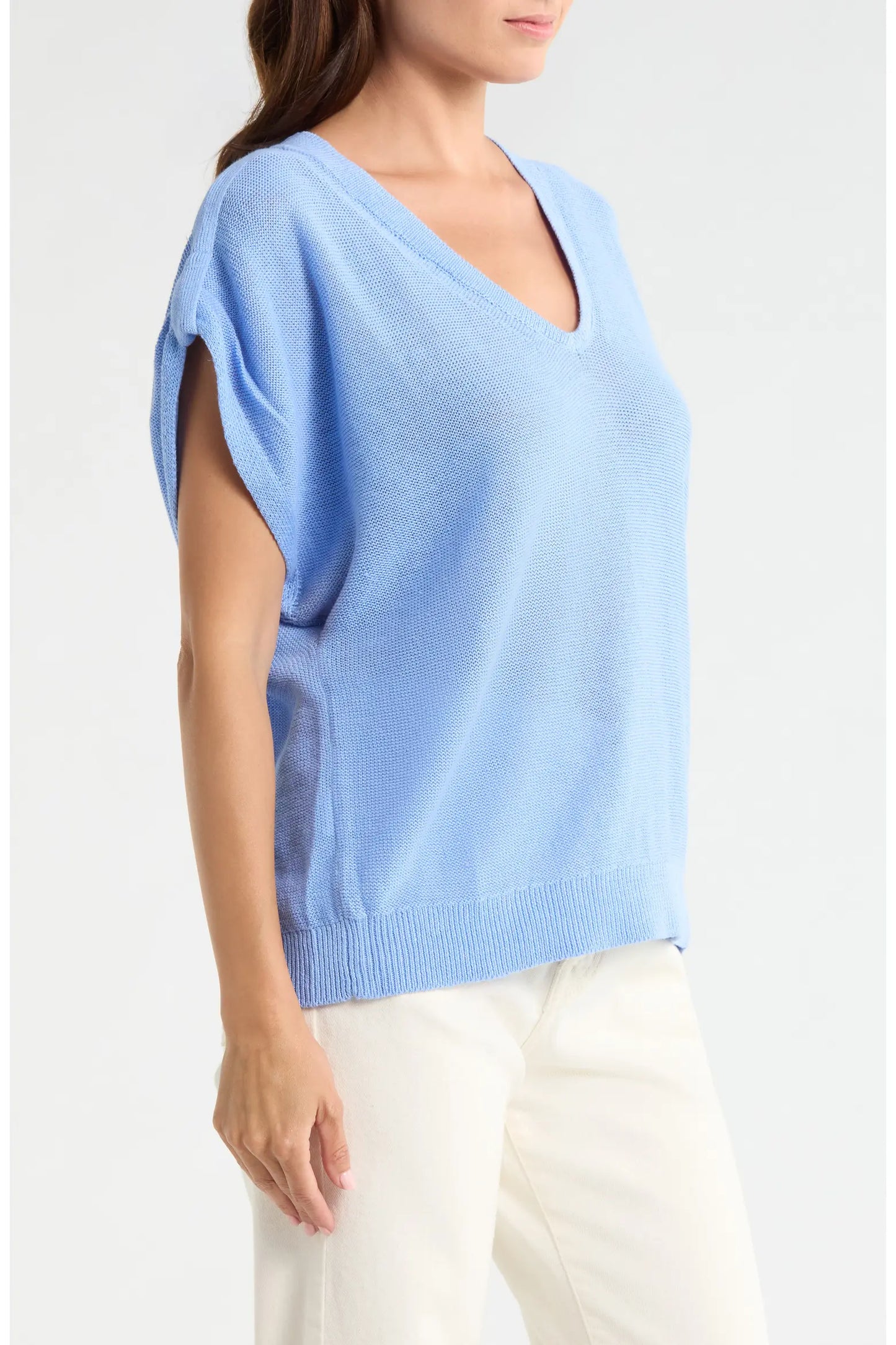 Light blue sweater worn by a person on a white background