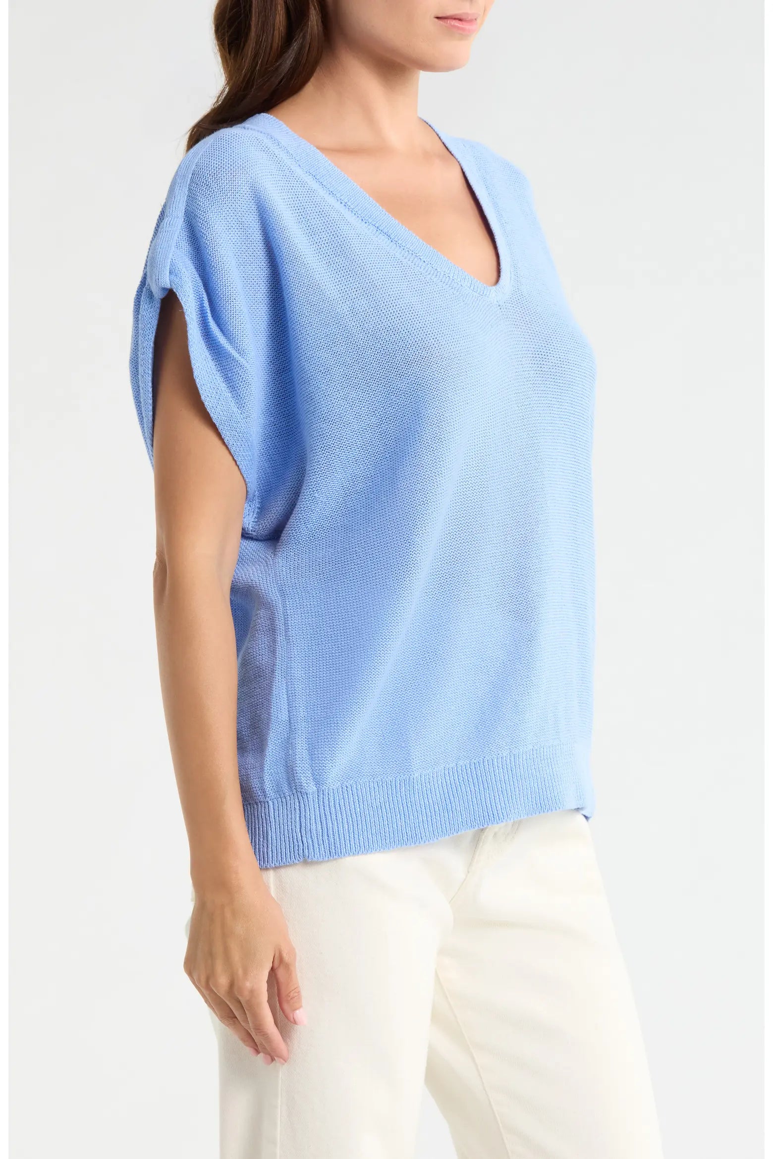 Light blue sweater worn by a person on a white background